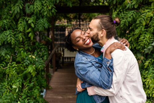 Man kisses woman on cheek for Salvage One engagement photo