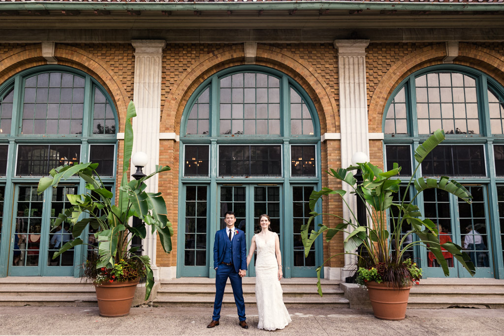 Bride and groom stand outside their Columbus Park Refectory wedding reception in Chicago