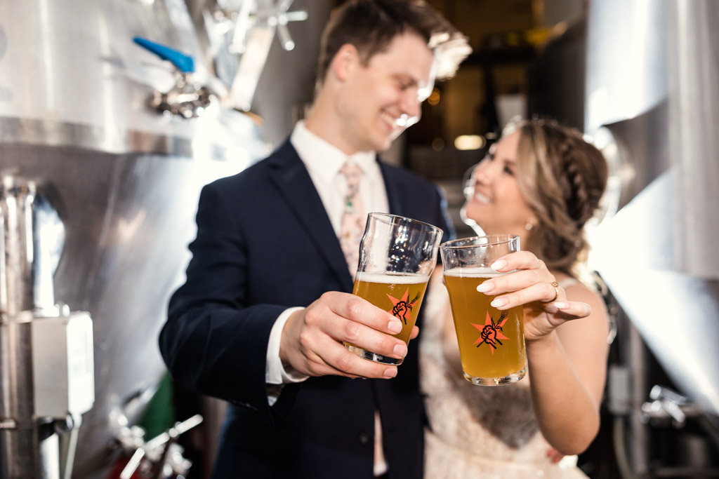 Bride and groom cheers beers at their Revolution Brewing wedding in Logan Square