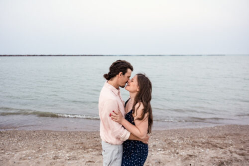 Romantic photo of couple kissing at Milwaukee lakefront outside South Shore Pavilion
