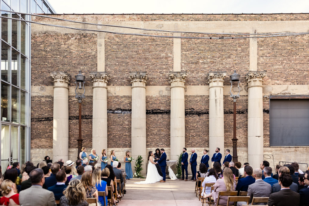 Artifact Events wedding ceremony in south courtyard with columns and greenery