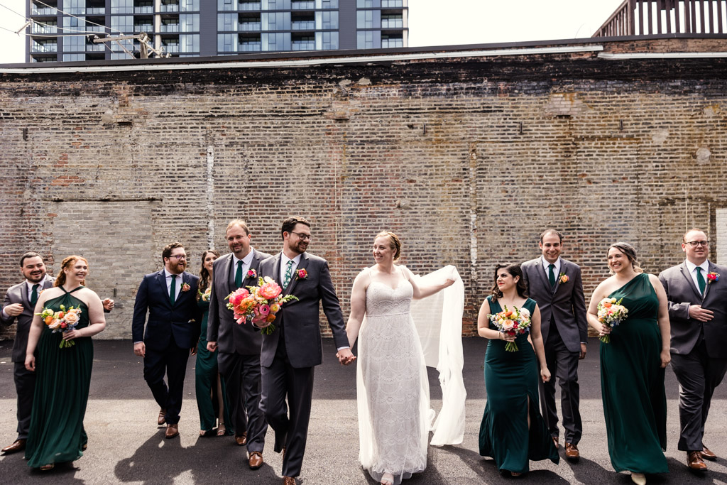 Candid photo of wedding party walking together outside Bottom Lounge wedding venue