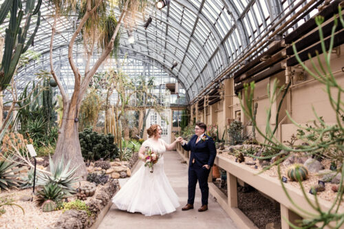 Fun photo of newlyweds dancing in Desert House at their Garfield Park Conservatory wedding