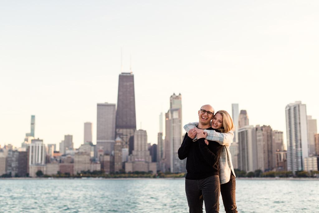 North Avenue Beach engagement photo of happy couple with Chicago skyline
