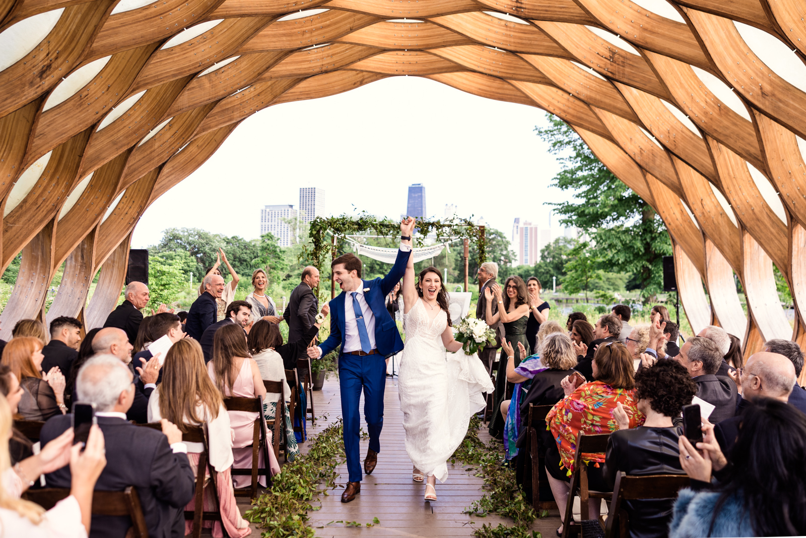 Happy newlyweds exit their Lincoln Park Honeycomb wedding ceremony by Chicago wedding photographer Emma Mullins Photography