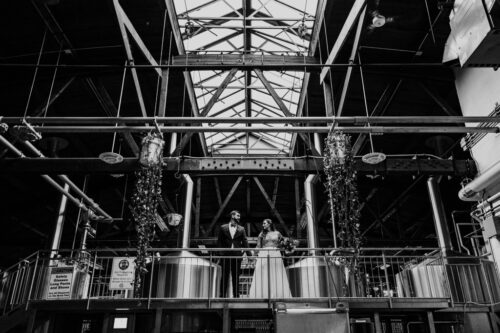 Half Acre Brewery wedding photo with beer tanks and skylight in Chicago