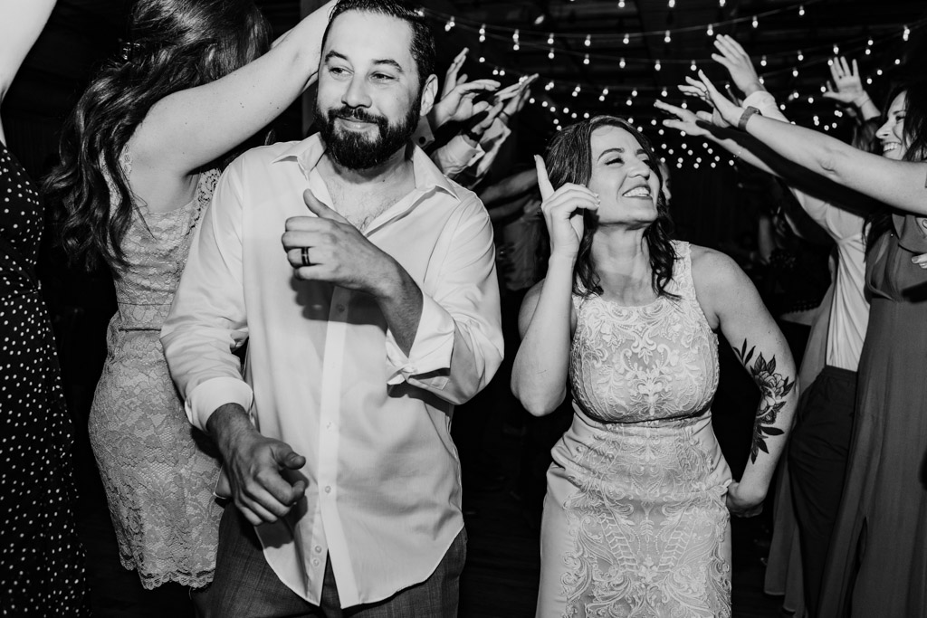 Happy bride and groom dance with their guests at Bridgeport Art Center wedding reception featuring live music