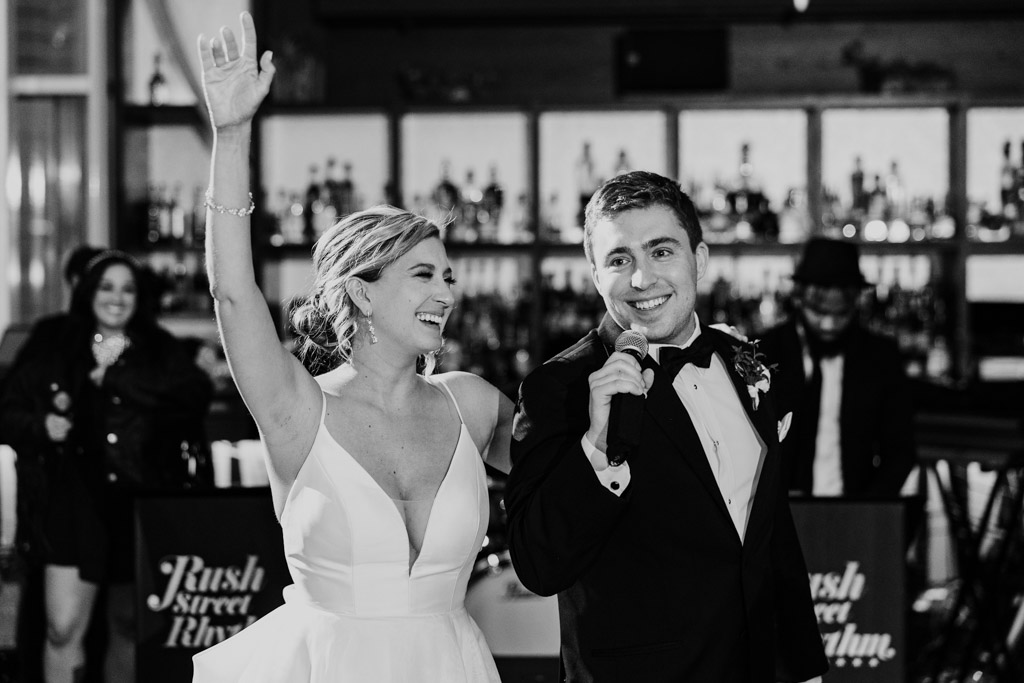 Happy newlyweds give speech to their guests during Chicago hotel wedding reception at ROOF on theWit