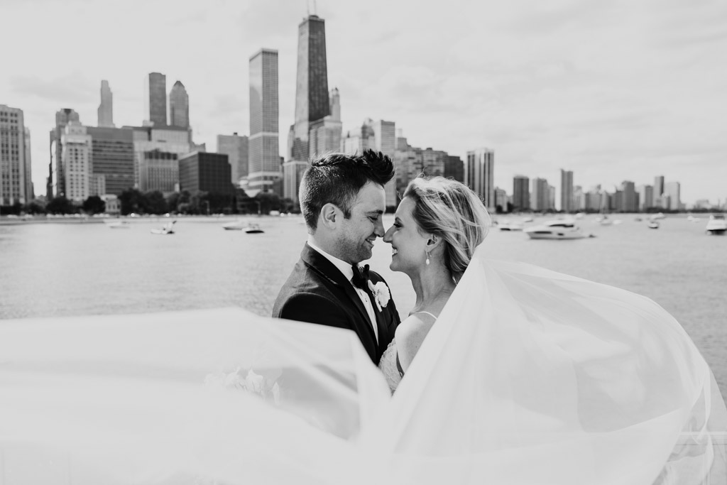 Romantic Chicago wedding photo of bride and groom with flowing veil at Olive Park with skyline