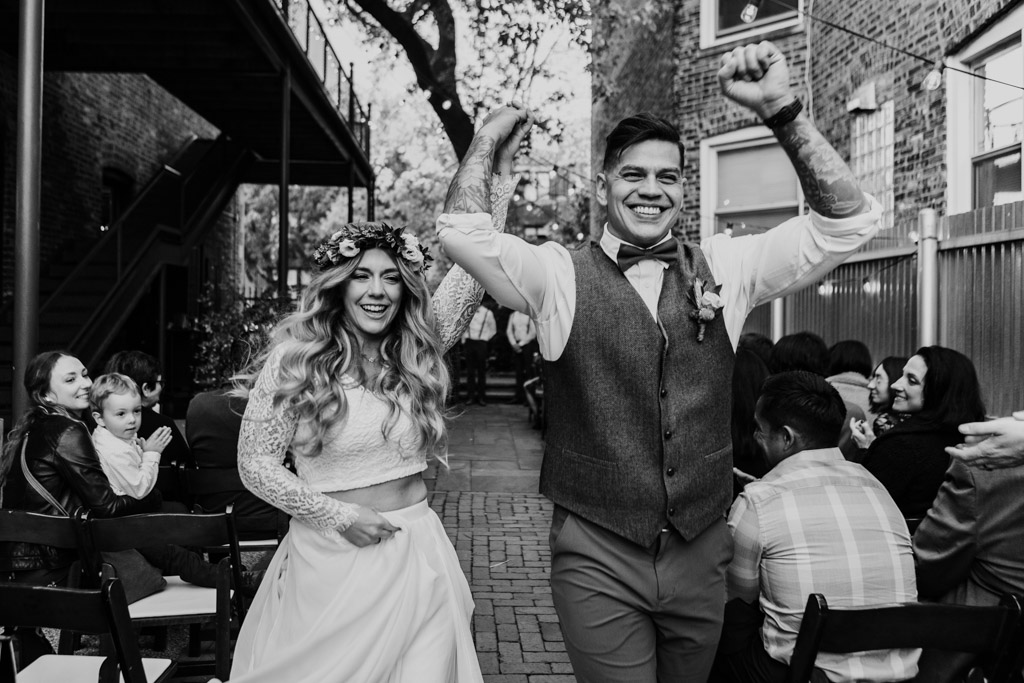 Just married bride and groom exit their fall outdoor wedding ceremony at Firehouse Chicago
