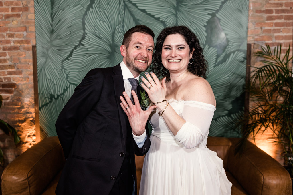 Fun photo of bride and groom showing off their rings during The Arbory wedding reception