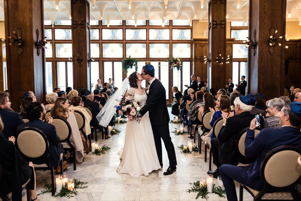 Bride and groom kiss in the White City Ballroom at their spring Chicago Athletic Association Hotel wedding