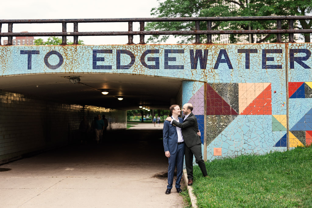 Engaged couple stand near Edgewater mural for their summer Chicago neighborhood engagement session