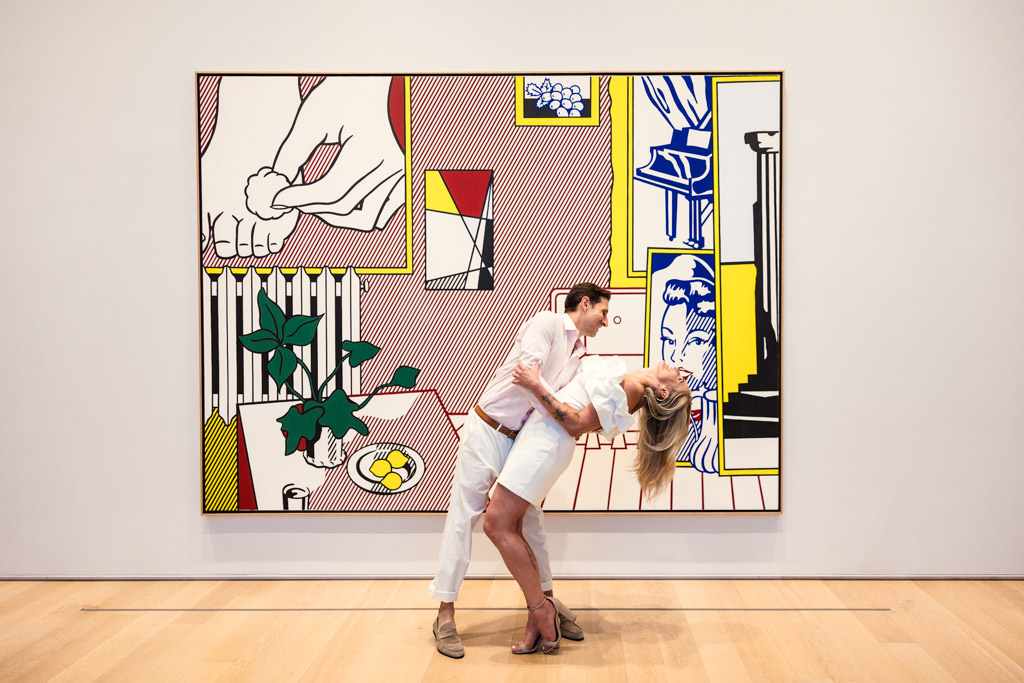 Art Institute of Chicago engagement photo of couple dancing in front of Lichtenstein piece in Modern Wing