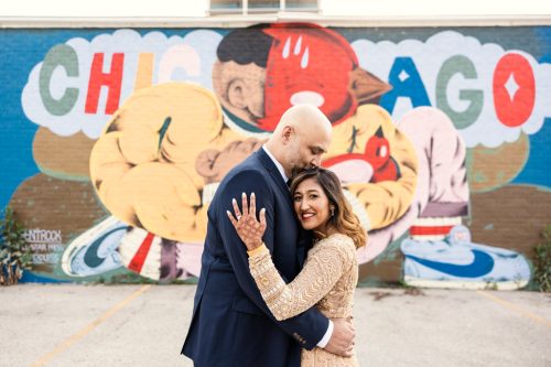 Portrait of bride and groom in front of colorful Chicago mural in West Loop neighborhood