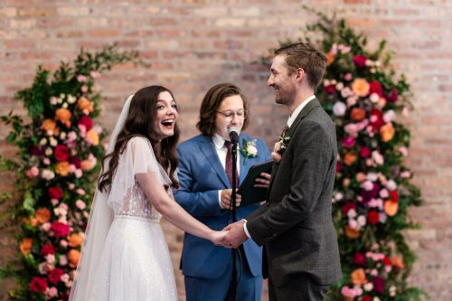 Bride and groom laugh during their wedding ceremony at Wildman BT in Chicago