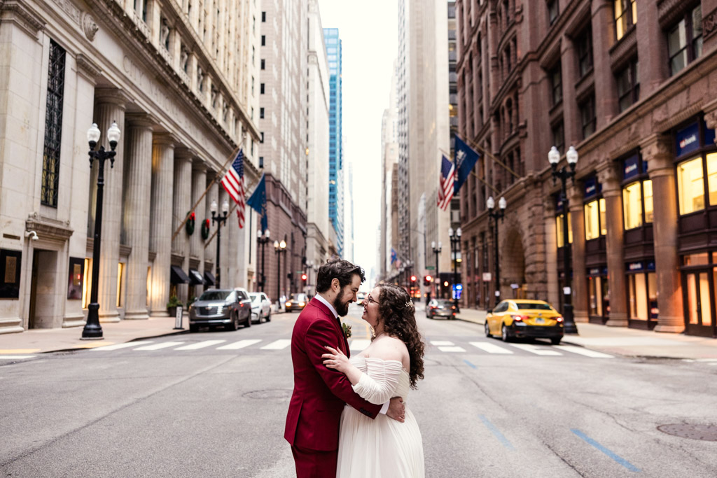 Romantic photo of bride and groom in LaSalle street downtown Chicago before their winter City View Loft wedding