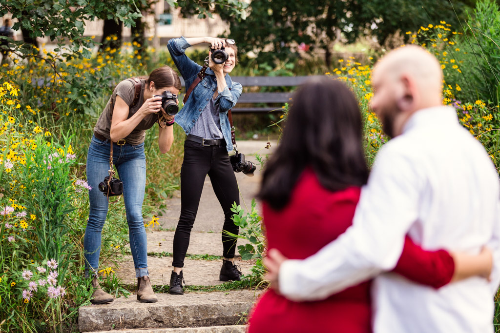 Two photographers during live shoot mentor session with an engaged couple in Humboldt Park by Emma Mullins Photography