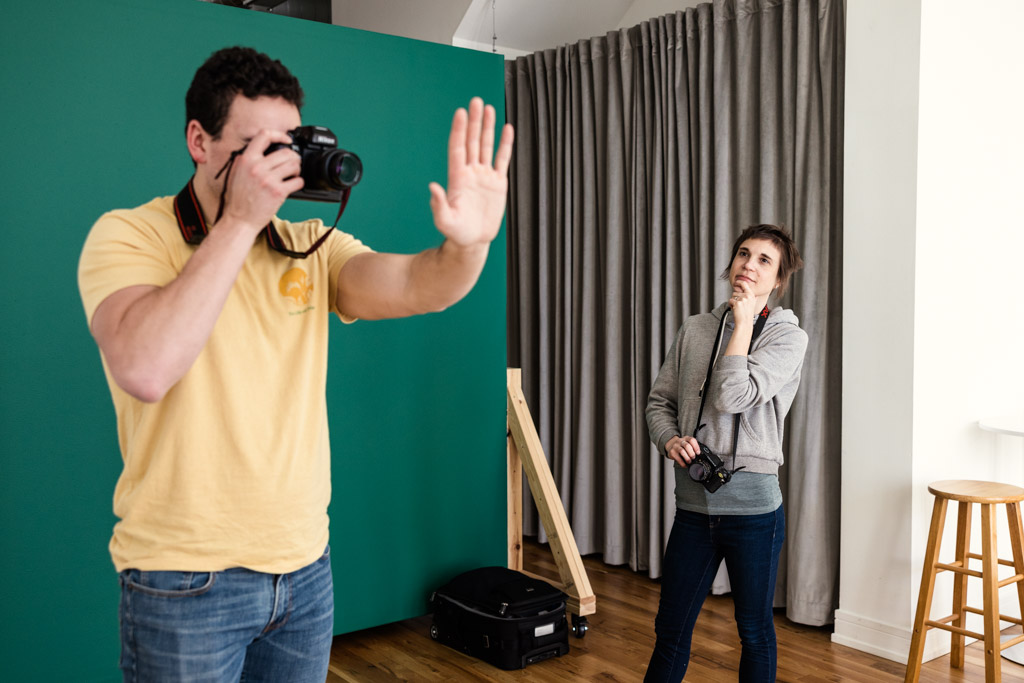 Student practices photographing hand for perspective exercise during mentor session with Emma Mullins Photography at P&M Studio Chicago