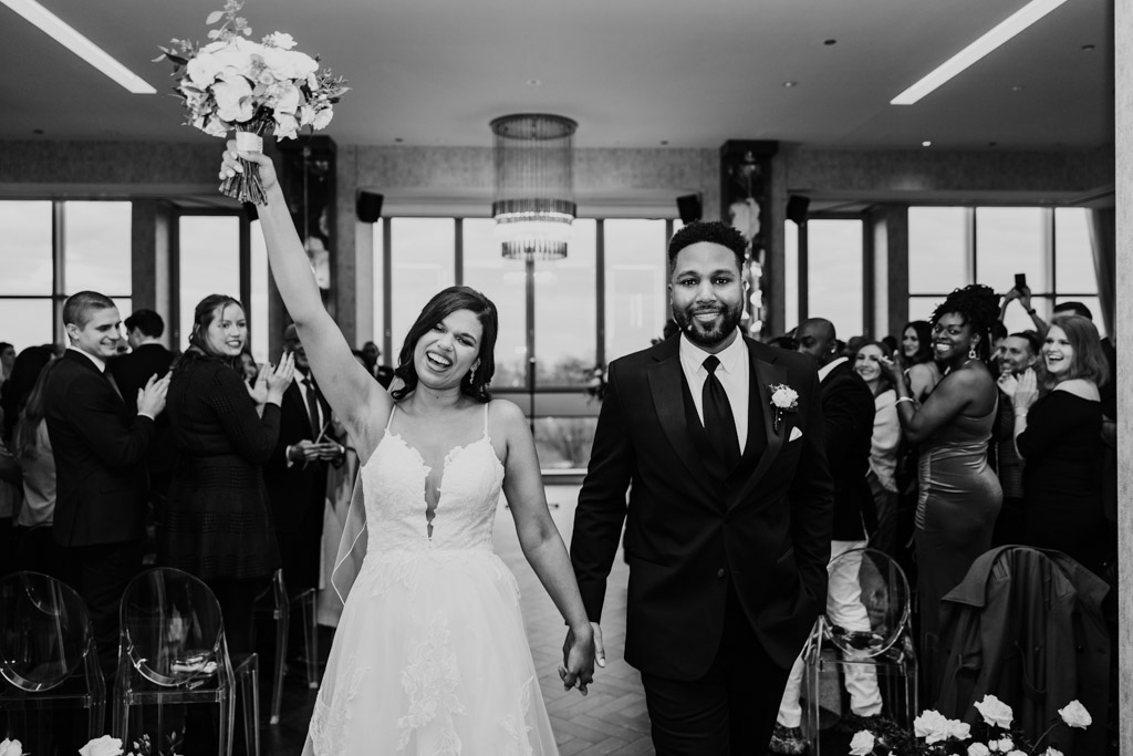 Just married bride and groom exit their LM Studio wedding ceremony while guests applaud
