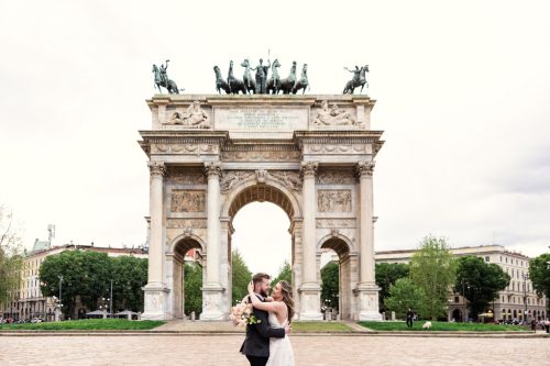 Romantic photo of bride and groom at Arco della Pace in Milan for their spring Parco Sempione wedding