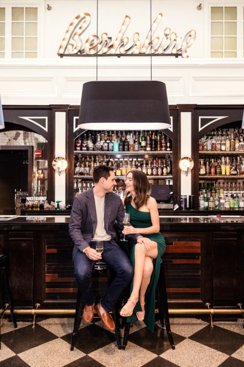 Chicago bar engagement photo of couple sipping champagne at Berkshire Room