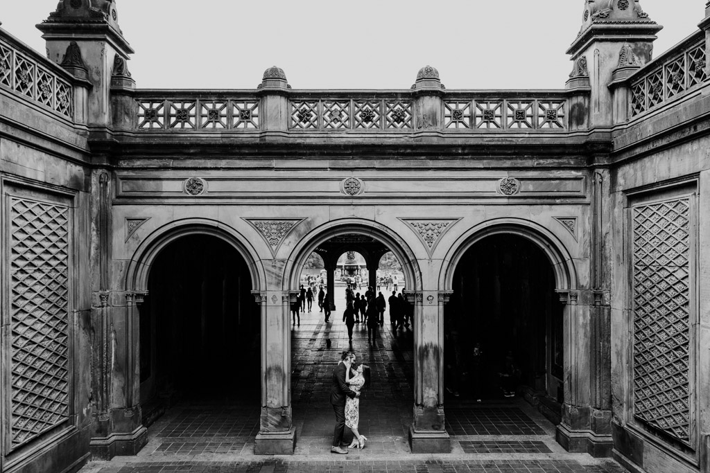 Romantic black and white engagement photo of couple at Bethesda Terrace in Central Park, NYC