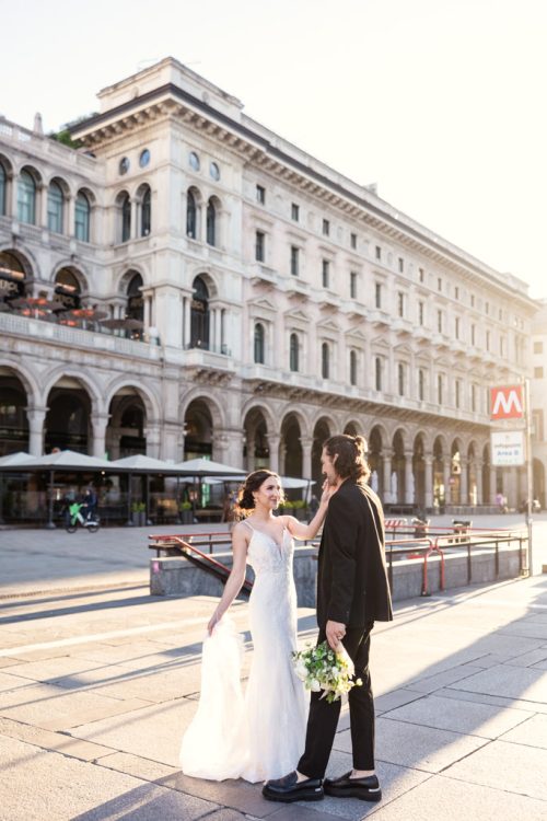 Bride and groom dance in morning light outside Milan Metro stop after Italy elopement
