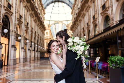 Happy bride and groom inside Galleria Vittorio Emanuele II after their downtown Milan wedding