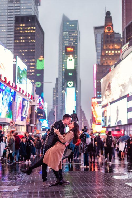 Romantic New York City engagement photo of couple dipping in street at Times Square
