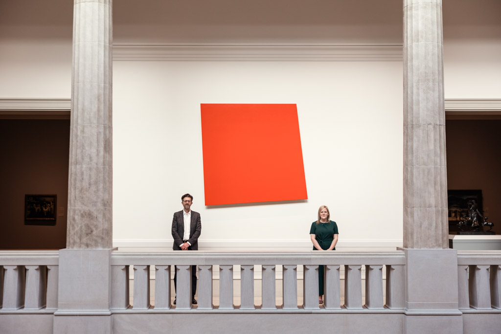 Creative photo of engaged couple standing on balcony with red shape at Art Institute of Chicago