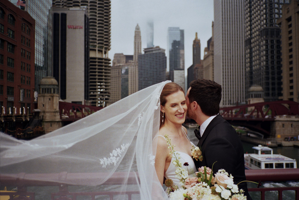 Romantic photo of bride and groom on Chicago bride with flowing veil captured on film