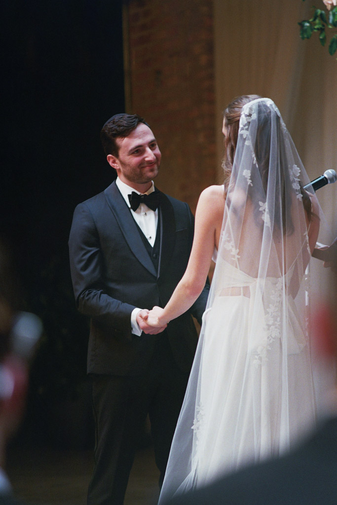 Groom looks lovingly at bride during wedding ceremony at The Arbory Chicago