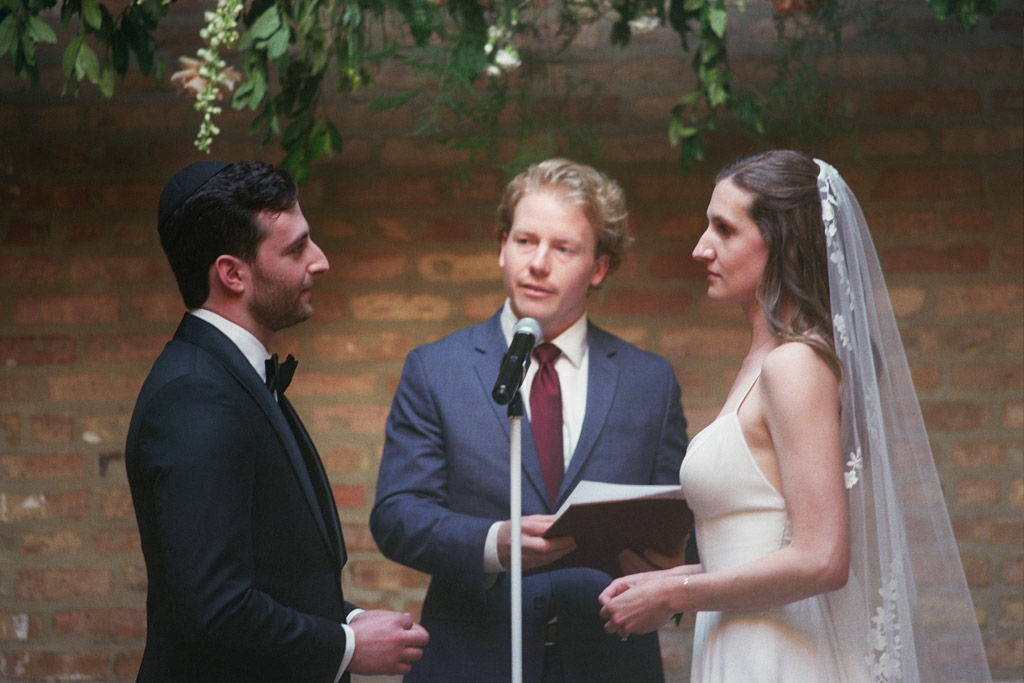Film photo of bride and groom exchanging vows during wedding ceremony at The Arbory Chicago
