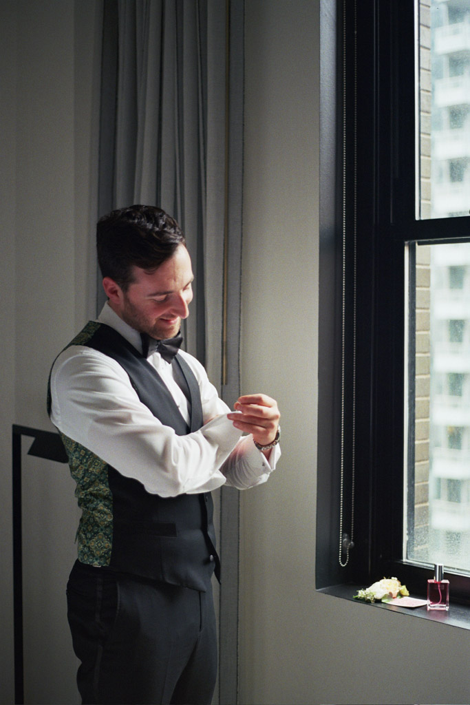 Groom gets ready in hotel room at Pendry Chicago captured on film