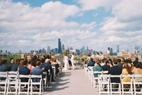 Rooftop wedding ceremony at Lacuna Lofts in Pilsen neighborhood with Chicago skyline view captured on film photography