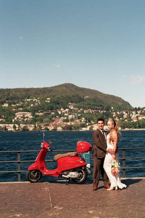 Film photo of bride and groom with red Vespa at Lake Como after their morning Italy elopement