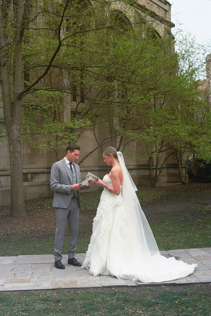 Bride and groom read vows to each other outside Bond Chapel on University of Chicago campus