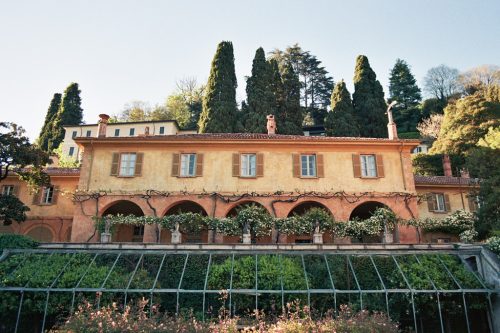 Exterior of Villa Pizzo wedding venue on Lake Como, Italy at golden hour with rose garden