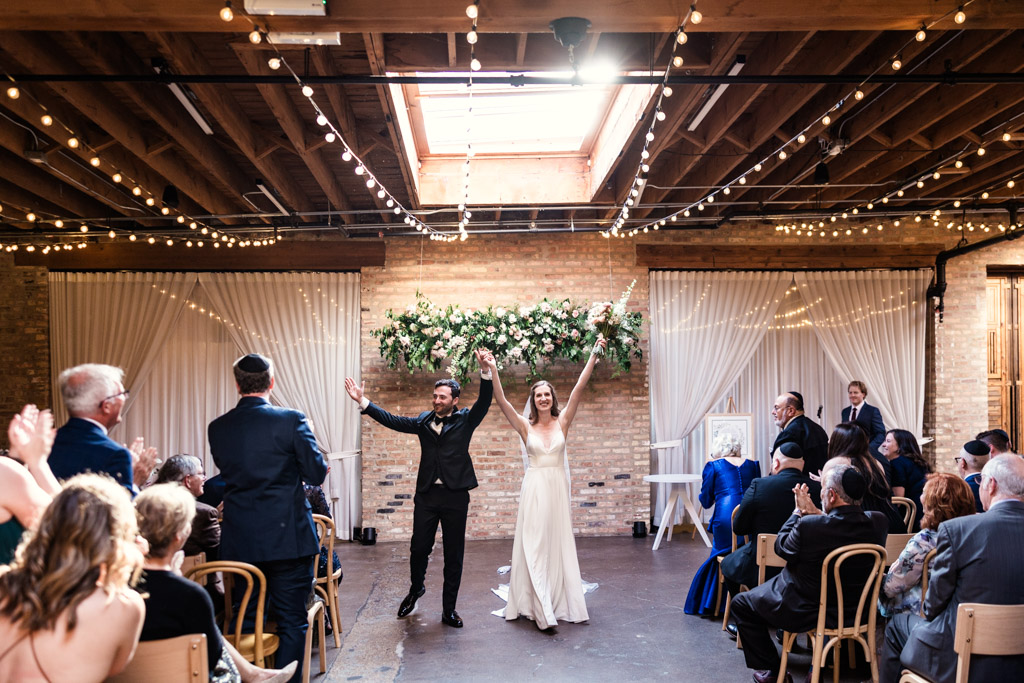 Newlyweds celebrate at the end of their wedding ceremony at The Arbory Chicago