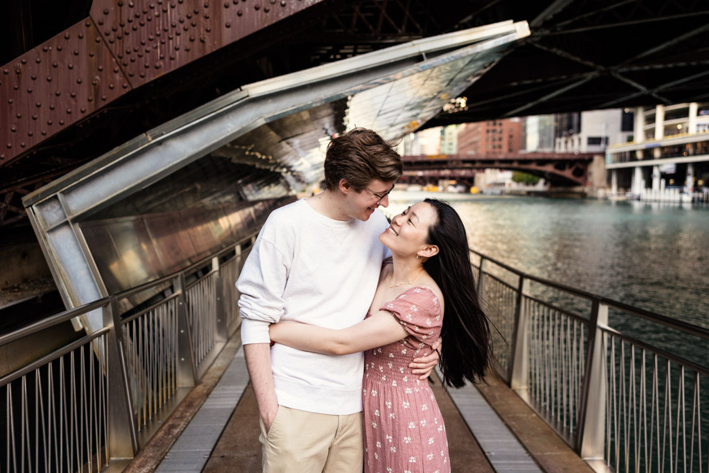 Romantic photo of couple on Chicago Riverwalk at their sunrise engagement session
