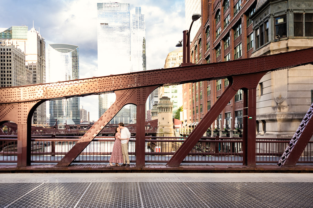 Romantic photo of couple on downtown Chicago bridge during their sunrise engagement session
