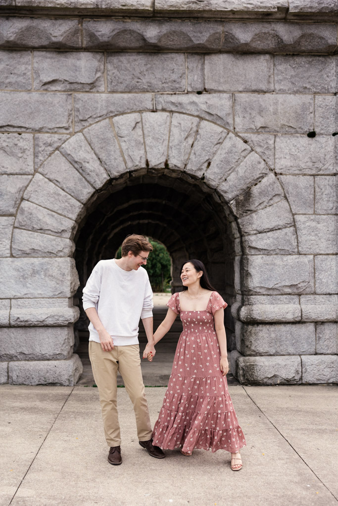 Happy couple walks near Ulysses S. Grant Monument. during sunrise Lincoln Park engagement session