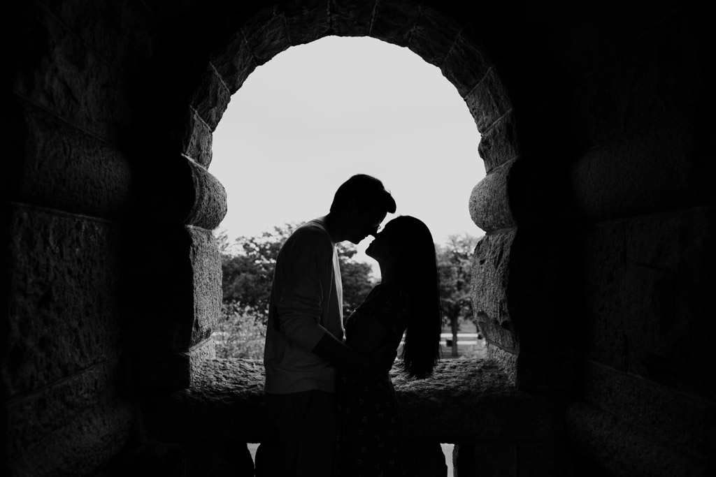 Black and white photo of engaged couple silhouetted in a window at the Ulysses S. Grant Monument in Lincoln Park