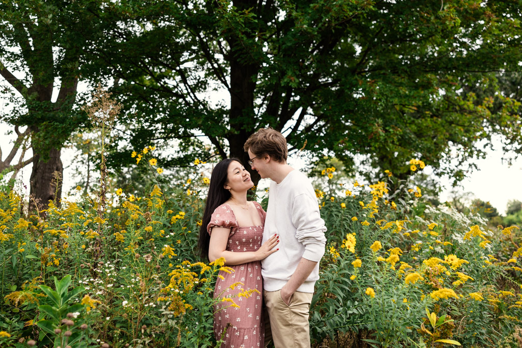 Engaged couple stands among yellow wildflowers in Lincoln Park