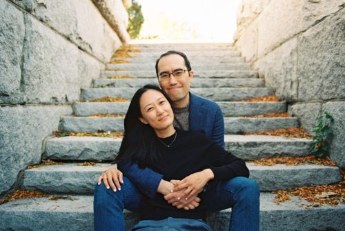 Film photo of couple sitting on stone steps of the Ulysses S. Grant Monument in Lincoln Park in Chicago during autumn engagement session
