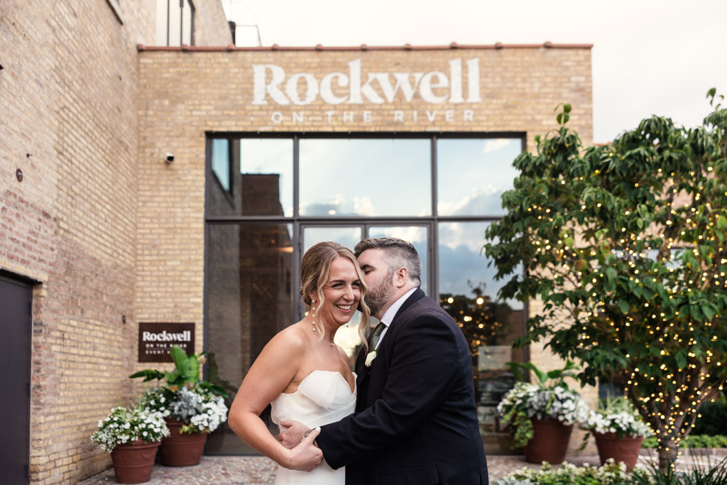 Candid photo of bride and groom outside Rockwell on the River before their wedding ceremony