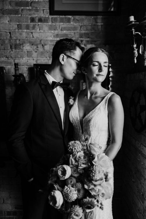 Candid black and white photo of bride and groom before their Salvage One Chicago wedding