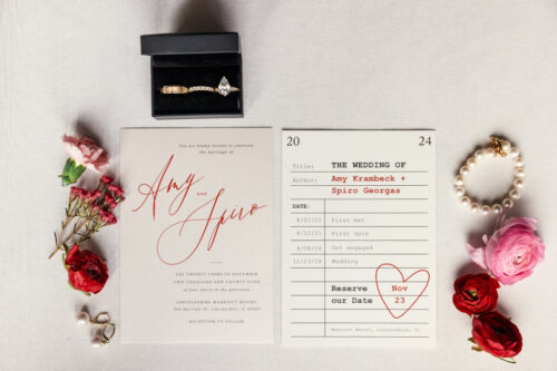 Wedding invitation with rings, flowers, and date reserved for November 23, 2024.