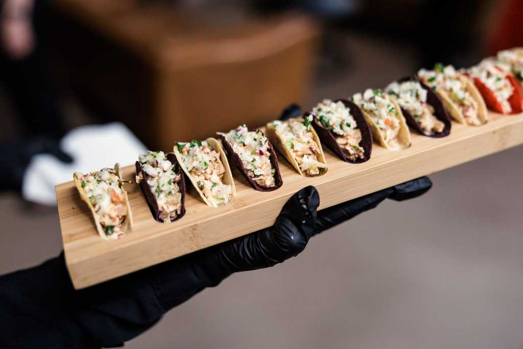 Tray of mini tacos with various fillings on a wooden tray for wedding reception at Ovation Chicago